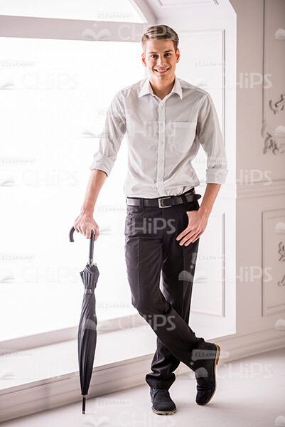 Young Businessman With Umbrella Stock Photo