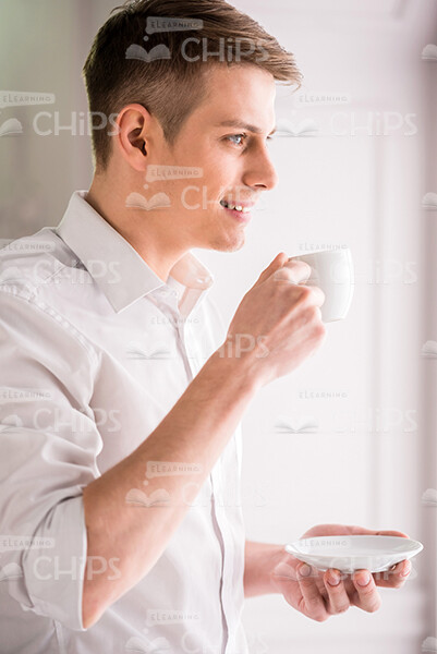 Half-Turned Young Business Man Drinking Coffee Stock Photo