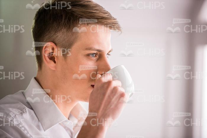 Concentrated Man Drinking Coffee Stock Photo