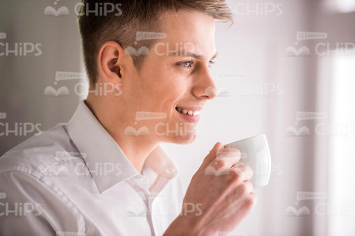 Smiling Guy Holding White Coffee Cup Stock Photo