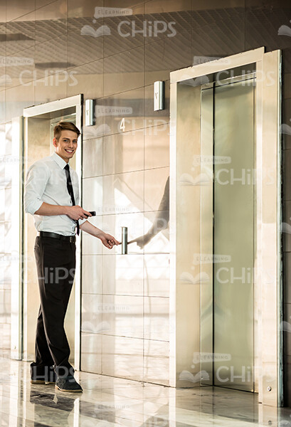 Presentable Young Man Pressing Elevator Button Stock Photo