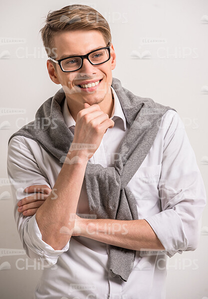 Smiling Man Standing In Thoughtful Pose Stock Photo