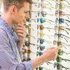 Stock Photo Of Young Man Choosing Glasses
