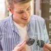 Nice Young Guy Looks At Glasses Stock Photo
