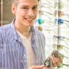 Handsome Teenage Guy Chose Glasses Stock Photo