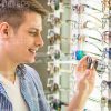Teenager Choosing Glasses In Shop Stock Photo