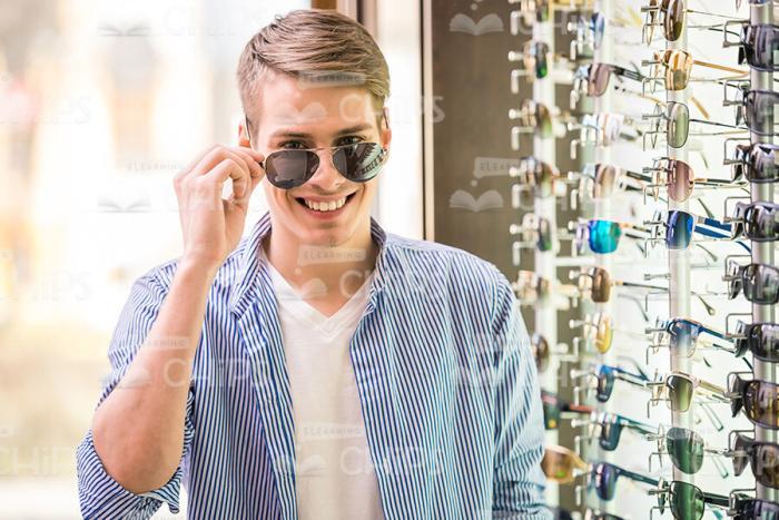 Young Man Trying On Glasses Stock Photo