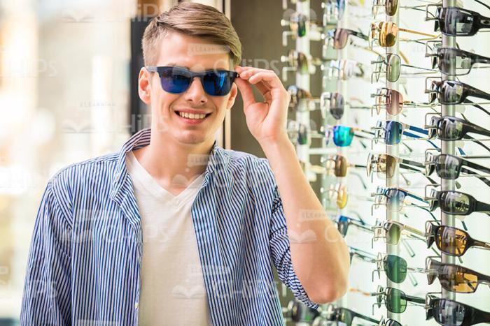Smiling Man Trying On Glasses Stock Photo