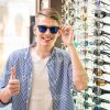 Nice Man At Sunglasses Shop Showing Thumb Up Stock Photo