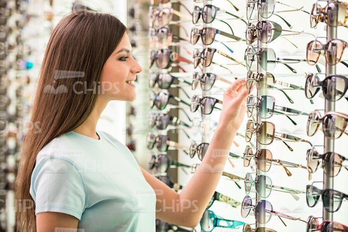 Nice Girl Looking For New Glasses Stock Photo