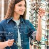Woman Holds Glasses And Looks On Them Stock Photo