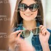 Young Lady Trying On Different Glasses Stock Photo