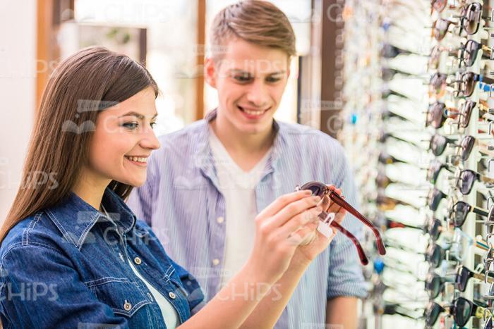 Shop Assistant Helps To Choose The Glasses Stock Photo