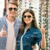 Couple Trying On Glasses And Making Thumb Up Gesture