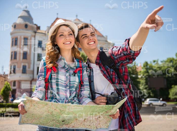 Tourist Pointing Forward While Showing Something To His Girlfriend Stock Photo