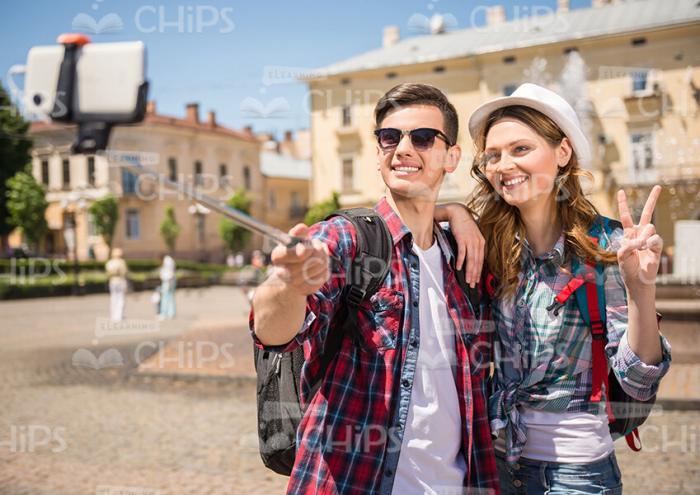 Smiling Tourists With Selfie Stick Stock Photo