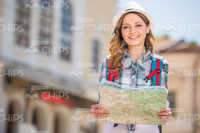 Female Traveler Holding Map Stock Photo