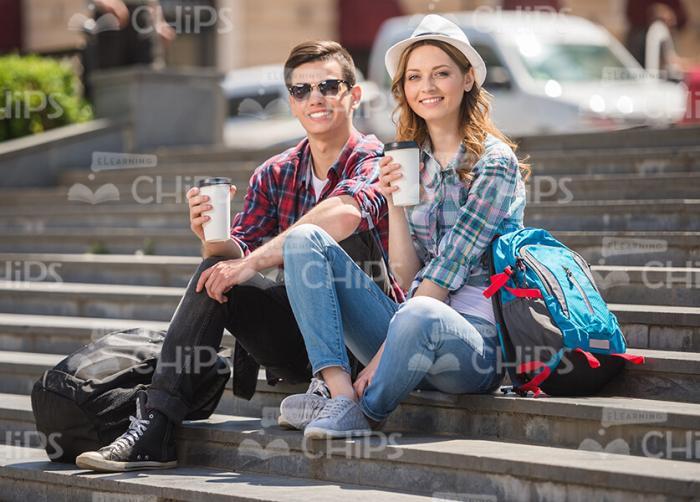 Nice Young Tourists Sitting On Stairs Stock Photo
