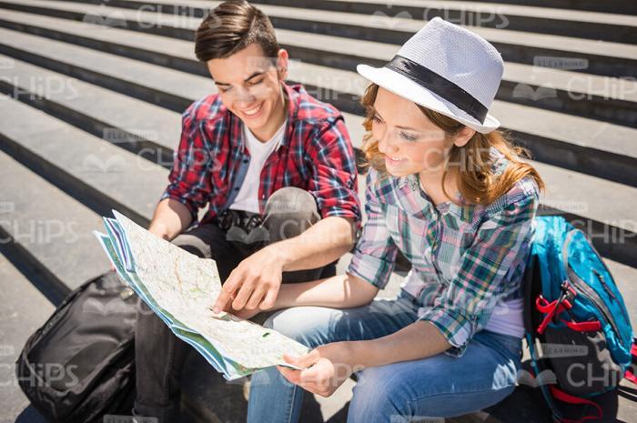 Handsome Tourists Look At Map Stock Photo