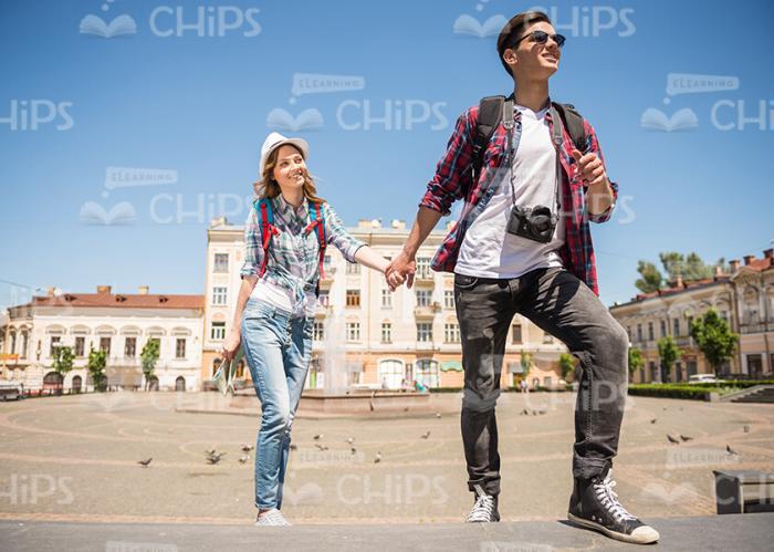 Two Pretty Young Tourists Holding Hands And Walking Stock Photo