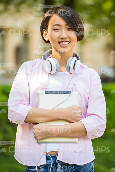 Young Asian Student Holding Tablet Stock Photo