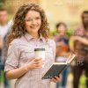 Curly Girl With Coffee Cup And Book Stock Photo