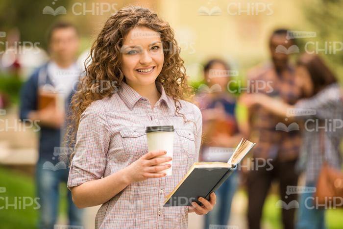 Curly Girl With Coffee Cup And Book Stock Photo