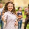 Stock Photo Of Curly Student Showing Thumb Up Gesture