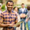 Happy African Student Using Tablet Stock Photo