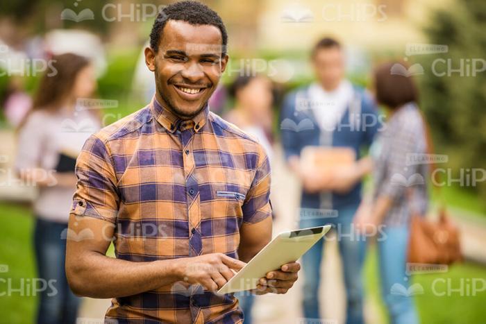 Happy African Student Using Tablet Stock Photo