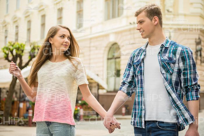 Stock Photo Of Young Couple Walking And Holding Hands