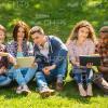Young People Resting On Grass Stock Photo