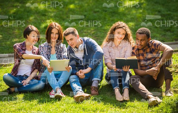 Young People Resting On Grass Stock Photo