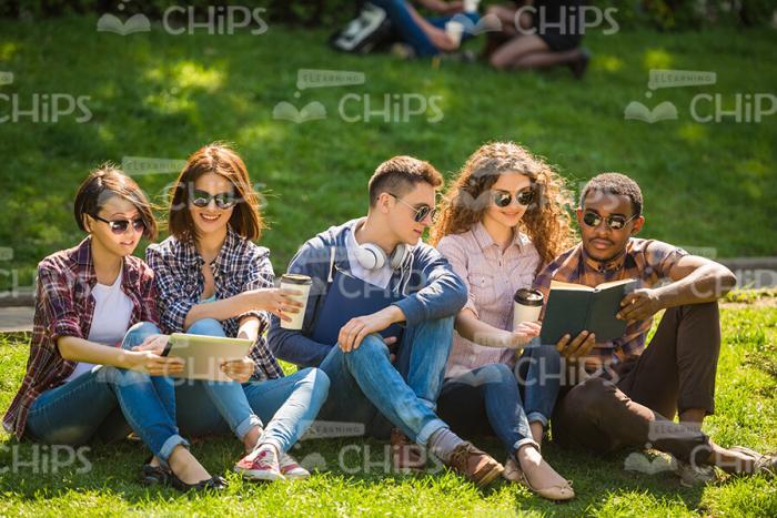 Happy Young Students Learning Outdoors Stock Photo
