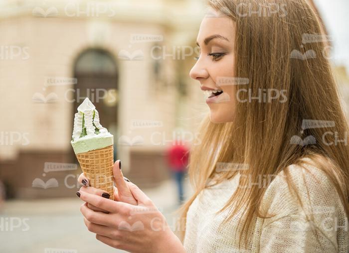 Surprised Woman Looking On Ice Cream In Her Hand Stock Photo