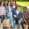 Happy Guys Sitting Outdoors Stock Photo