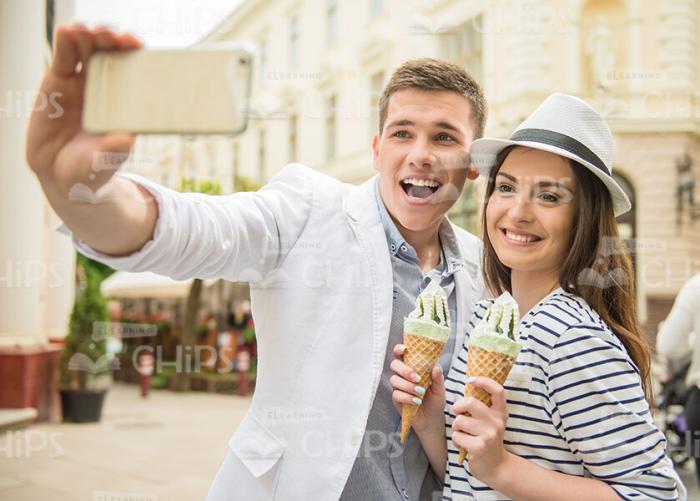 Couple Holds Ice Cream And Makes Selfie Together Stock Photo