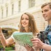Smiling Young Couple With Map Stock Photo