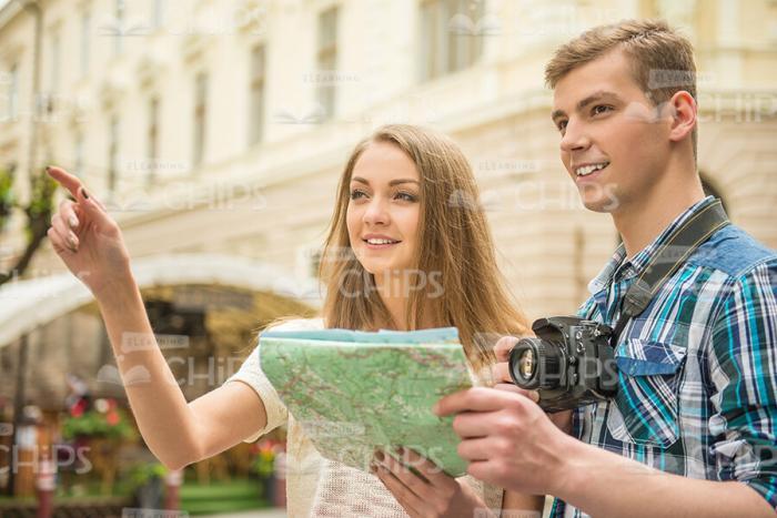 Smiling Young Couple With Map Stock Photo