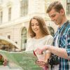 Handsome Young Couple Looking At Map Stock Photo