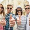 Friends Making Thumbs Up Gesture Stock Photo