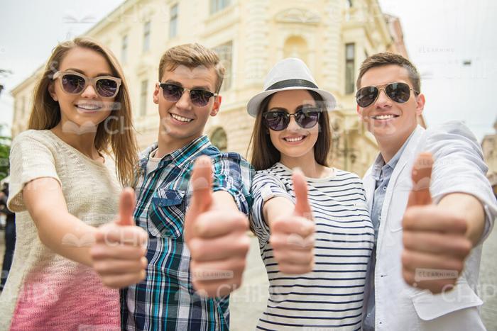 Friends Making Thumbs Up Gesture Stock Photo