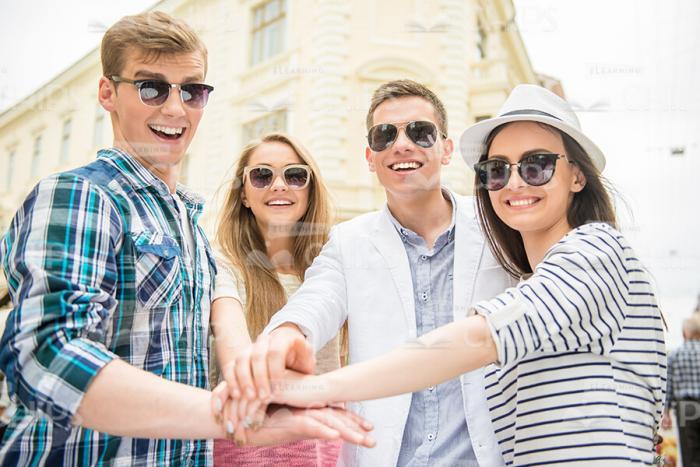 Young Students Making The "Hand On Hand" Gesture Stock Photo