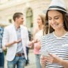 Girl In Stripped T-shirt Texting To Somebody Stock Photo