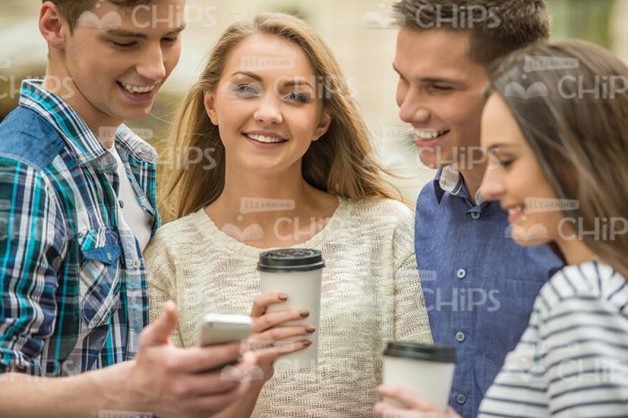 Group Of Friends Walking, Talking And Drinking Coffee Stock Photo