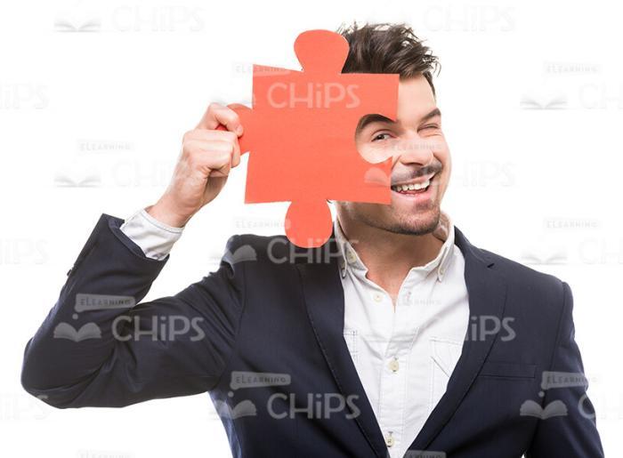 Young Man Looking Through Puzzle Piece Stock Photo