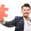 Smiling Man With Piece Of Puzzle Stock Photo