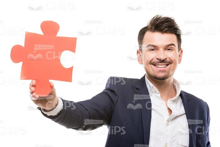 Smiling Man With Piece Of Puzzle Stock Photo