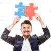 Smiling Man Connects Puzzles Stock Photo