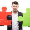 Handsome Man With Two Large Puzzle Pieces Stock Photo